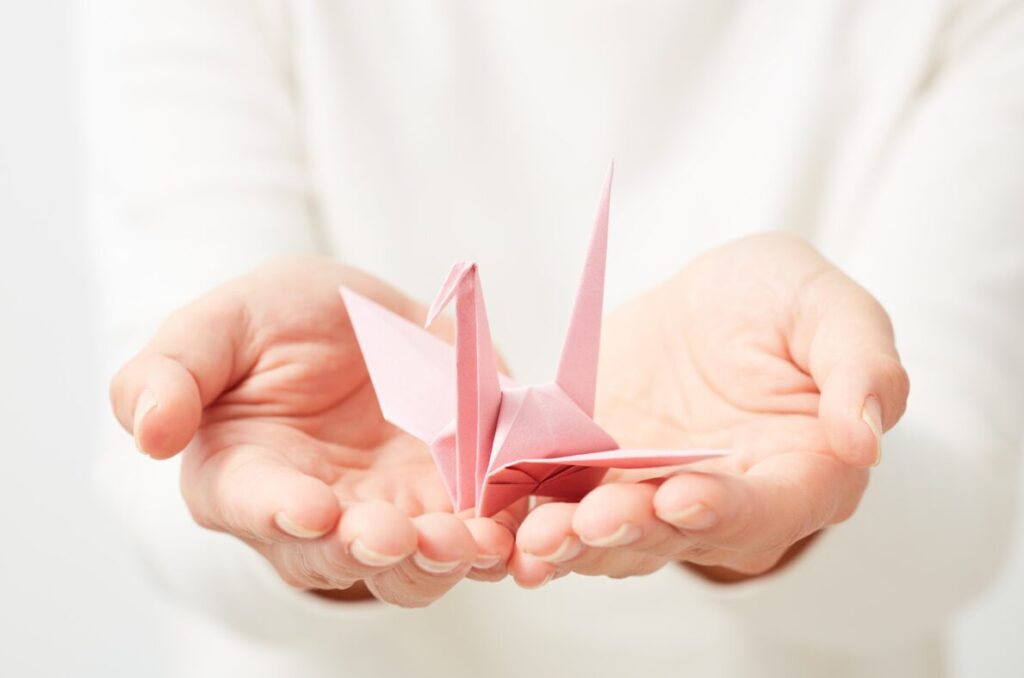 origami in hands origami - relaxing budget-friendly hobby