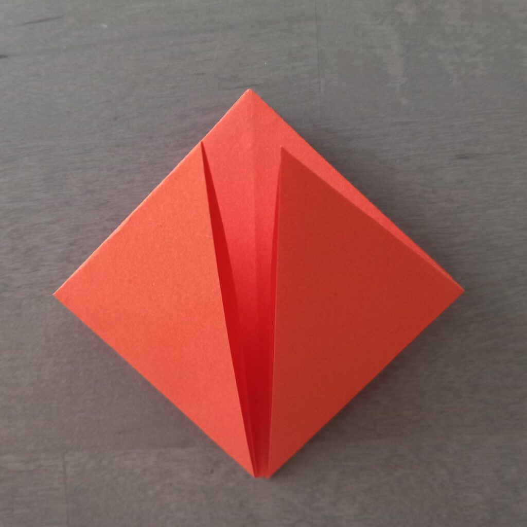 DIY Halloween lantern step 5 Step 5: Flipping paper over to repeat folds and form square shape.