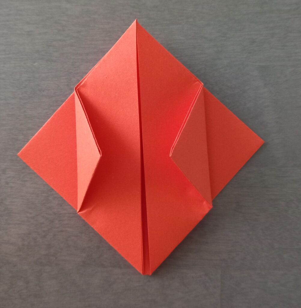 DIY Halloween lantern step 6 Step 6: Folding top layer corners to center line on origami square lantern.