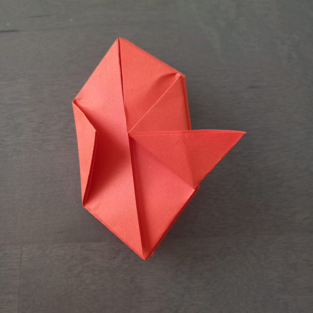 DIY Halloween lantern step 7 Step 8: Folding bottom corner into right angle for DIY origami string lights