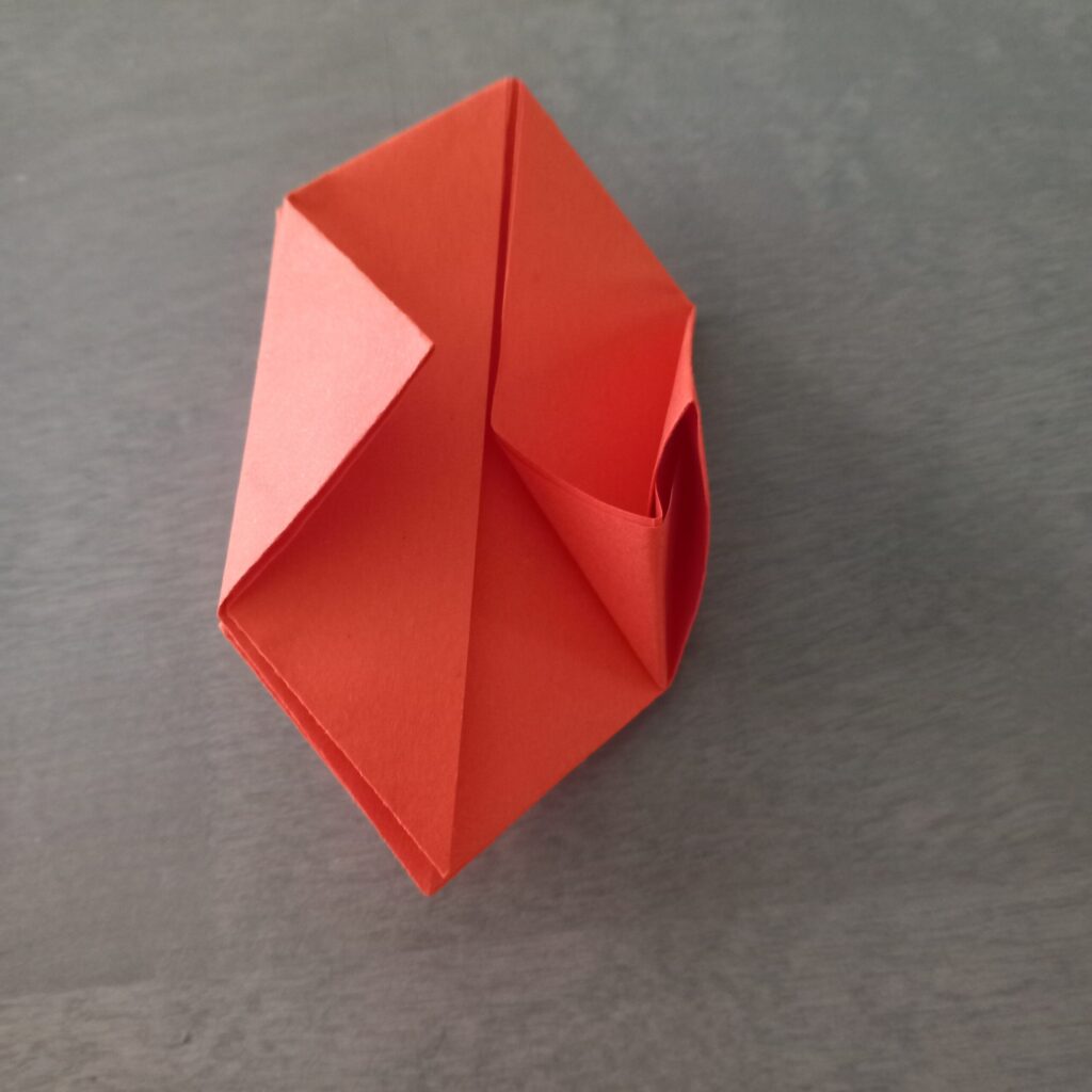 lantern origami step 12 Step 10: tucking folded part into triangle pocket for lantern origami