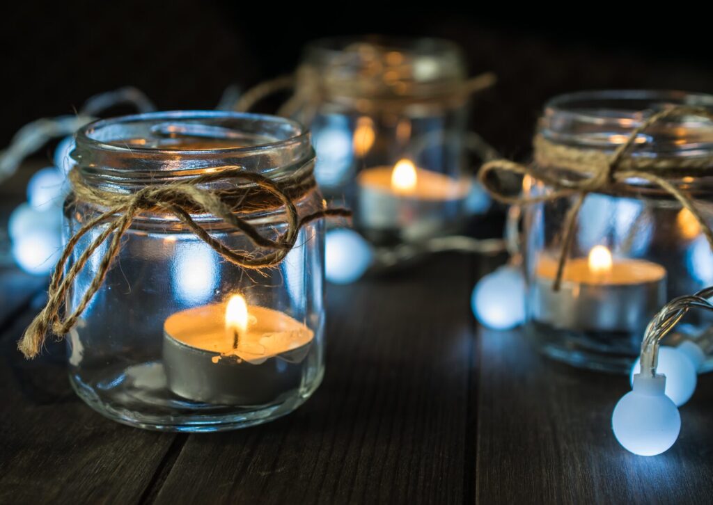 tea candles in glass jars decorated with rustic twine as a frugal autumn decor idea