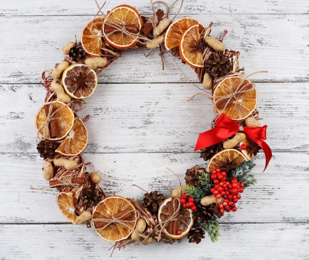 Wreath made of dried oranges and natural materials for autumn decoration